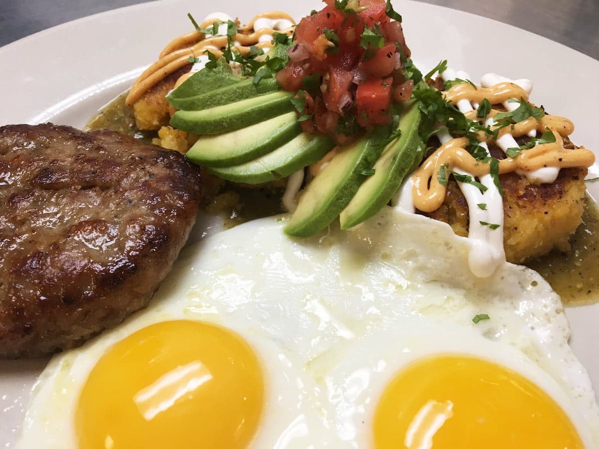 Sweet corn cakes breakfast plate with avocado and pico de gallo at Bailey’s Breakfast & Lunch in Omaha